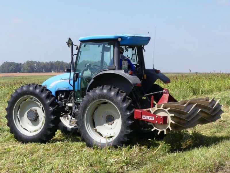 Tractor lifting the Kuys Industries roller crimper